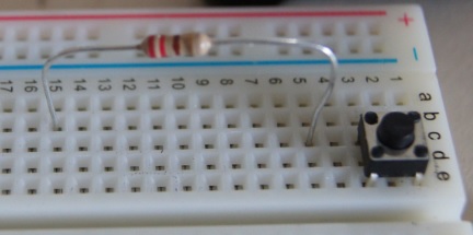 Detail of a resistor connecting two nodes on a breadboard