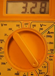 Multimeter showing 3.28 volts