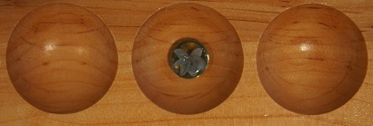 Mancala board with one stone in the second pocket.