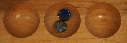 Mancala board with two stones in the second pocket.