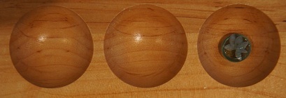 Mancala board with one stone in the third pocket.